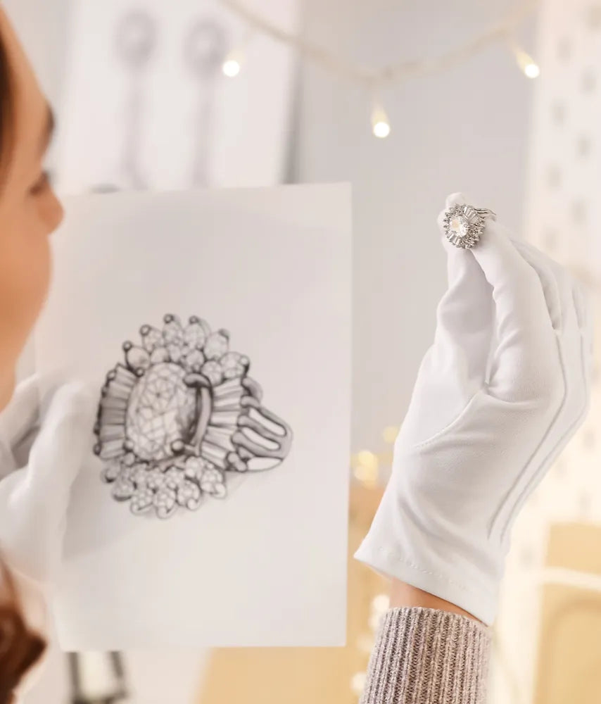 Designer holding a ring sketch and a diamond