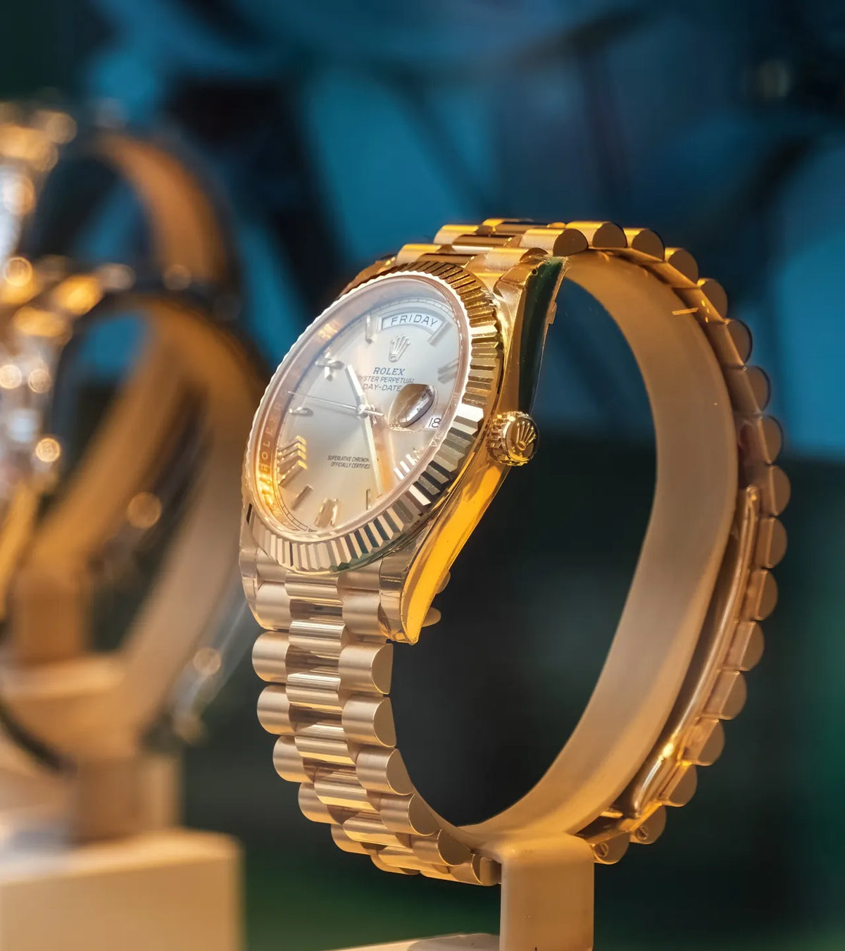 Gold Rolex Day-Date on a display stand