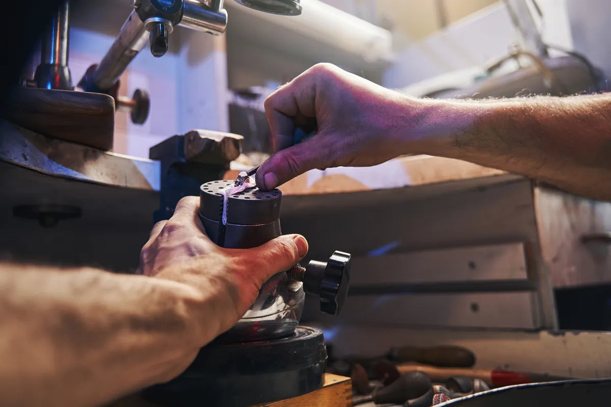 Jeweler setting a stone at the bench