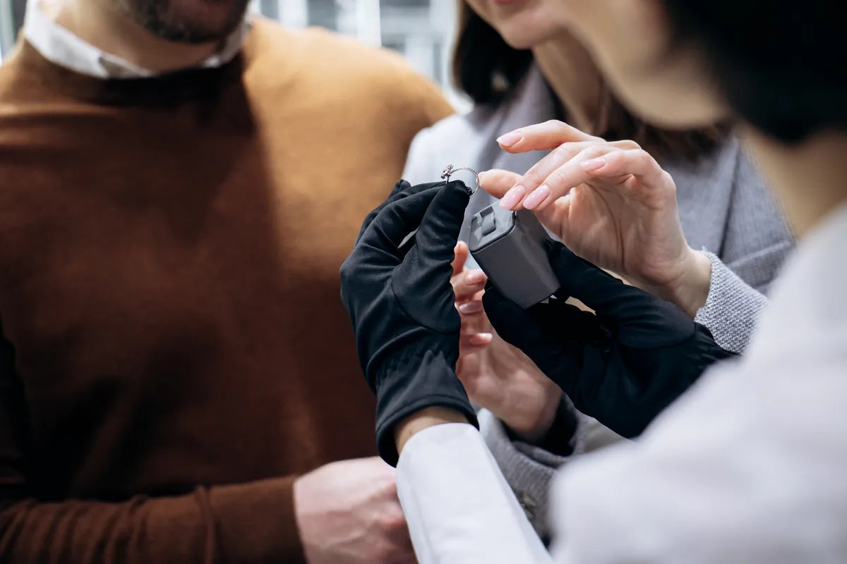 Specialist examining a watch with a client